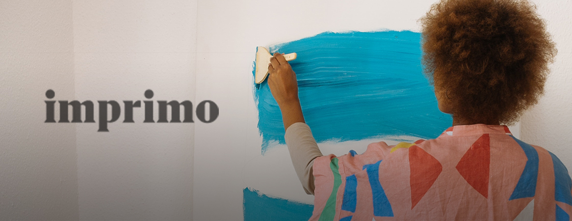 A woman of colour painting a canvas