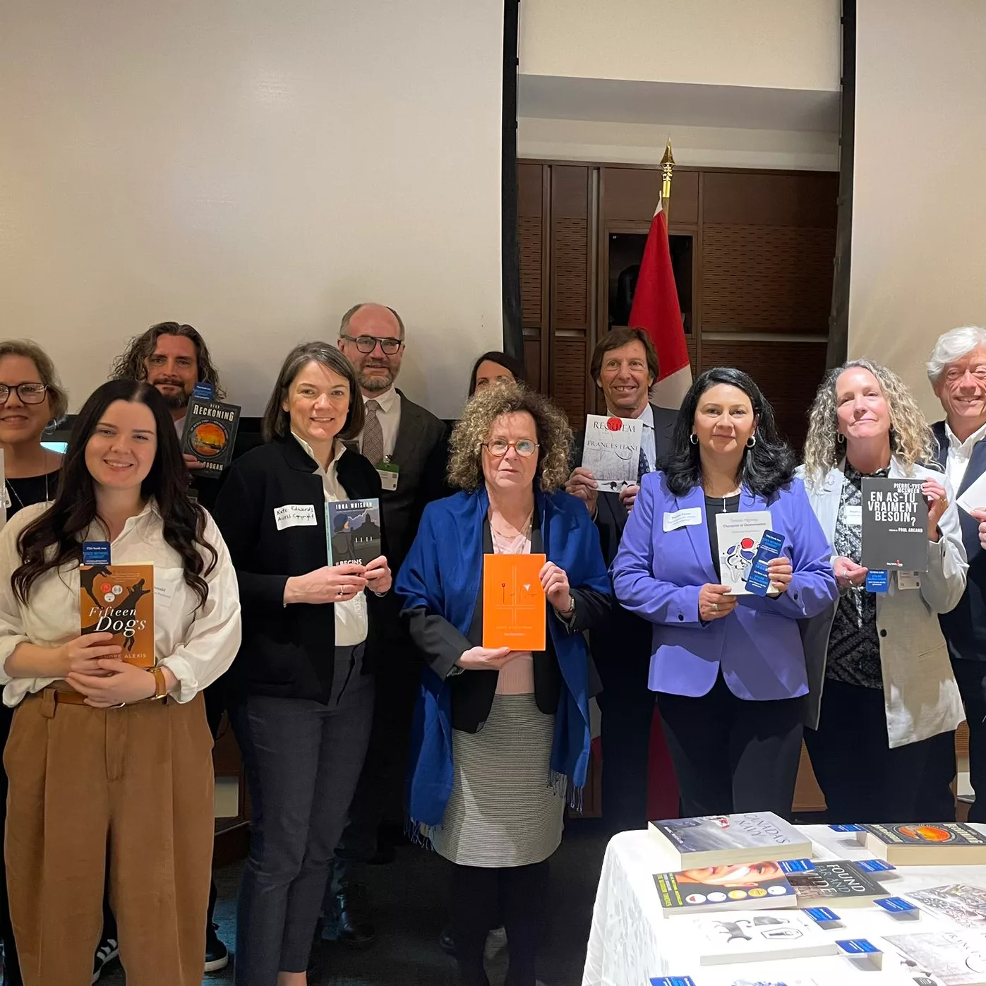 Group of people posing with books in hand