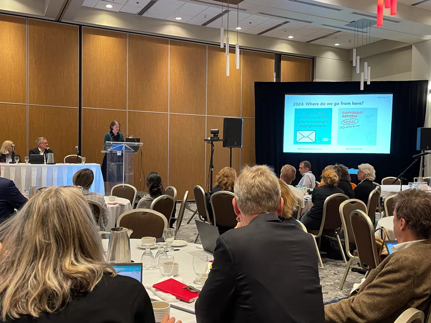 Kate Edwards speaking at podium